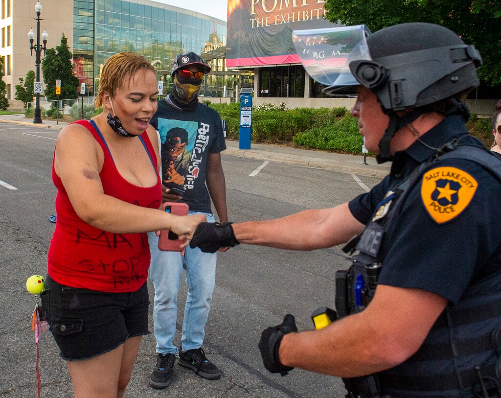 (Rick Egan  |  The Salt Lake Tribune)       Victoria Crosby with Black Lives Matter, gives a fist-bump with a Salt Lake CIty Police officer, during a demonstration in Salt Lake City, Tuesday, June 2, 2020.