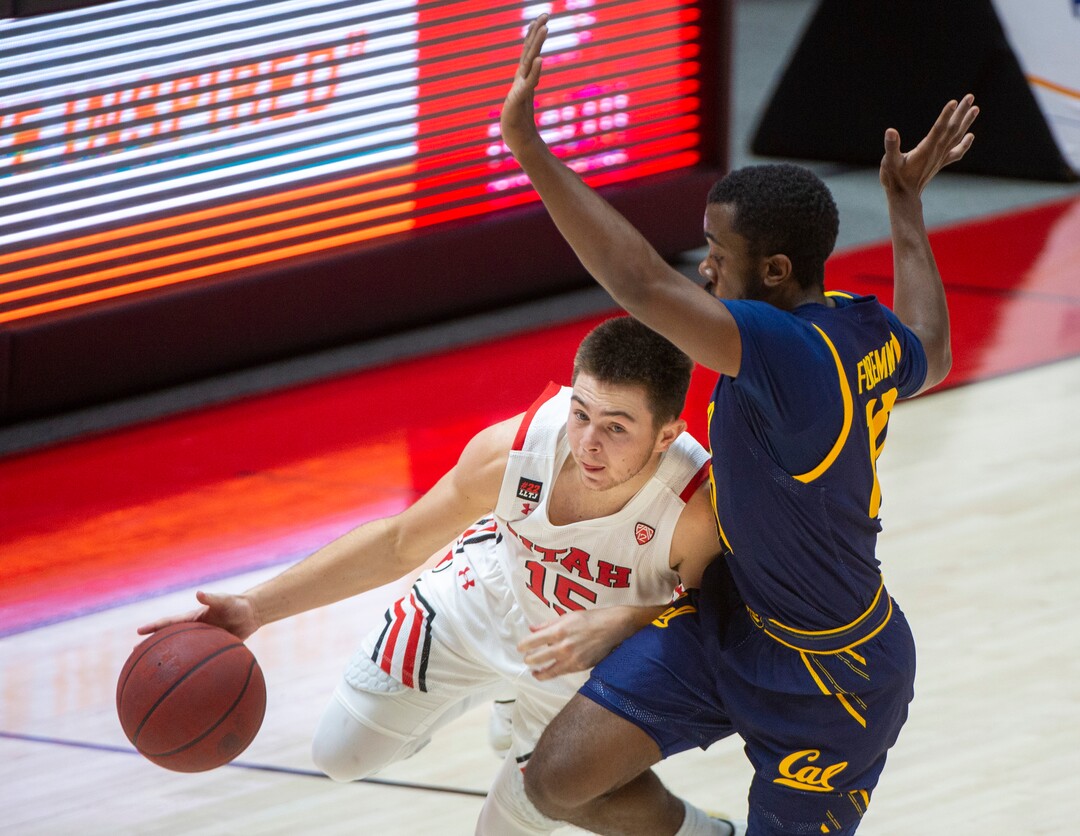 (Rick Egan | The Salt Lake Tribune)  Utah Utes guard Rylan Jones (15) takes the ball downcourt as California Golden Bears guard Makale Foreman (10) defends, in PAC12 Basketball action between the Utah Utes and the California Golden Bears, on Wednesday, Jan. 16, 2021.