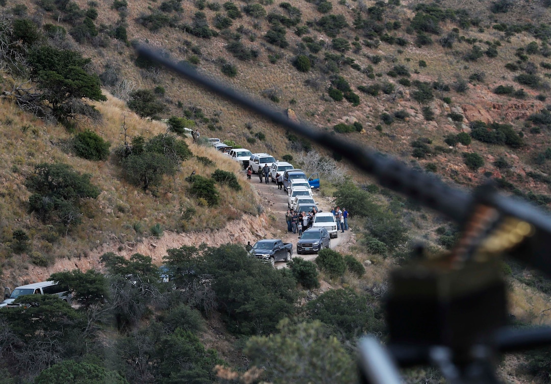 (Marco Ugarte | AP) Heavily armed Mexican authorities guard a caravan of friends and relatives of the LeBaron family as they arrive at the site where nine U.S. citizens, three women and six children related to the extended LeBaron family, were slaughtered when cartel gunmen ambushed three SUVs along a dirt road near Bavispe, at the Sonora-Chihuahua border, Mexico, Wednesday, Nov 6, 2019. Three women and six of their children, related to the extended LeBaron family, were gunned down in an attack while traveling along Mexico's Chihuahua and Sonora state border on Monday.