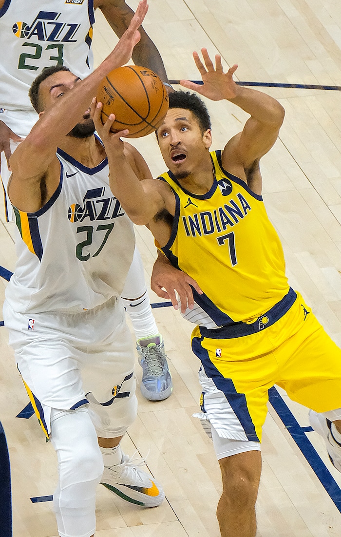 Leah Hogsten | The Salt Lake Tribune Utah Jazz center Rudy Gobert (27) stops Indiana Pacers guard Malcolm Brogdon (7) under the net as the Utah Jazz host the Indiana Pacers, April 16, 2021 at the Vivint Arena.