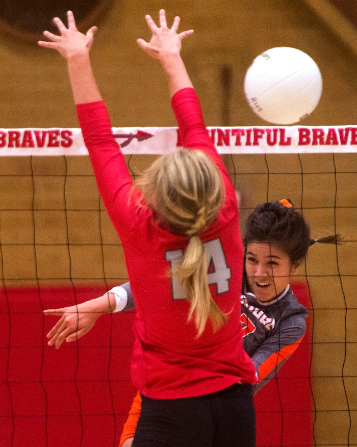(Rick Egan  |  The Salt Lake Tribune)  Naomi Pulu (27), Skyridge, hits the ball past Bri Mortensen, 14, Bountiful, in volleyball action, Bountiful vs. Skyridge, at Bountiful High, Wednesday, September 6, 2017.