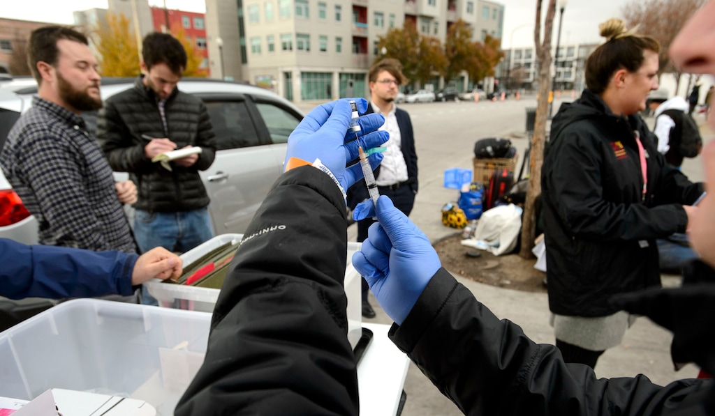 (Steve Griffin  |  The Salt Lake Tribune) Steven Beach, a registered nurse with the Salt Lake County Health Department, prepares a Hepatitis A vaccination dose at a mobile vaccination clinic setup outside at 500 west and 200 south in Salt Lake City Thursday November 16, 2017. The department is setting up the clinics to address the county's outbreak of Hepatitis A . There have been 66 cases here so far this year, mostly in homeless community.
