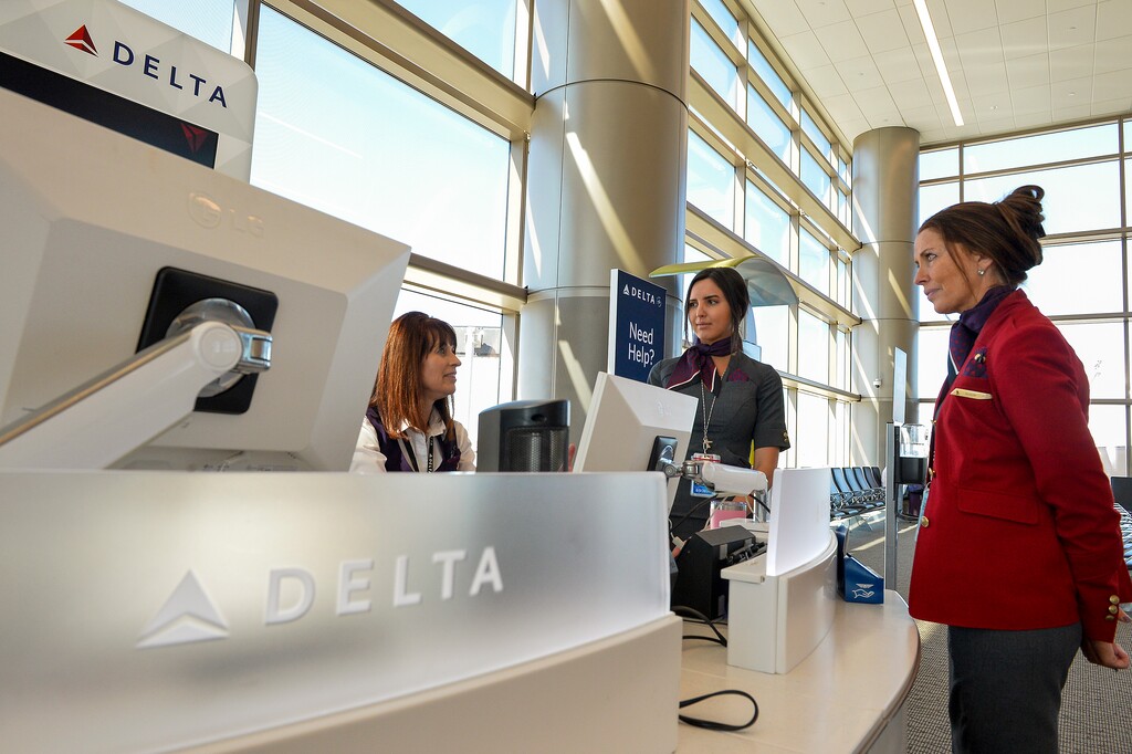 (Chris Samuels | The Salt Lake Tribune) Delta Air Lines employees converse at Salt Lake City International Airport, Wednesday, Oct. 12, 2022.