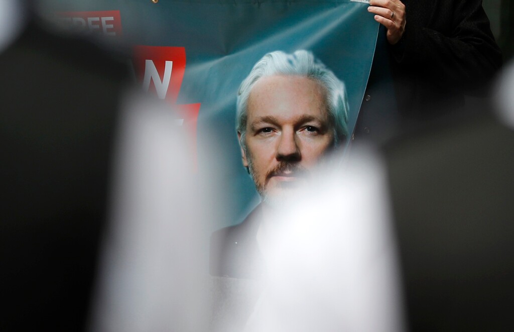 (Frank Augstein | AP file photo) Police watch Julian Assange supporters protesting outside Westminster Magistrates Court in London, Friday, June 14, 2019. Sweden on Tuesday dropped its investigation into an alleged rape by the WikiLeaks founder.