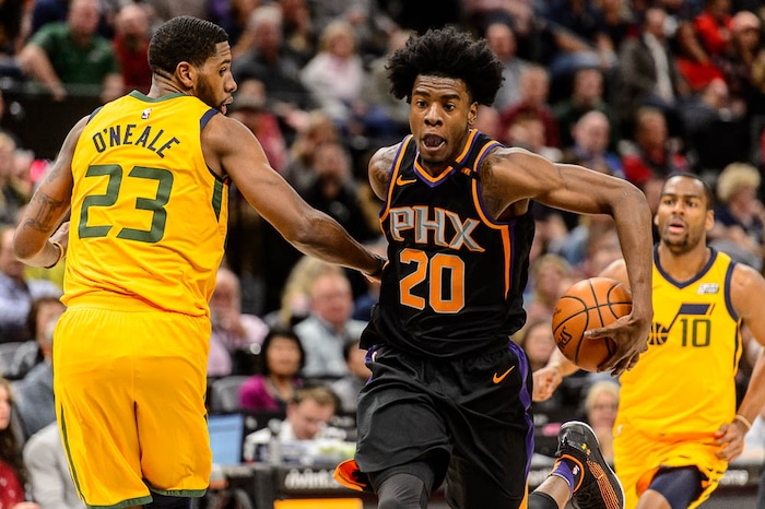 (Trent Nelson | The Salt Lake Tribune)  Phoenix Suns forward Josh Jackson (20) dribbles past Utah Jazz forward Royce O'Neale (23) as the Utah Jazz host the Phoenix Suns, NBA basketball in Salt Lake City, Wednesday Feb. 14, 2018.