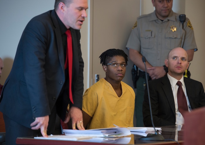 Scott Sommerdorf | The Salt Lake TribuneGerald Grant looks up at his defense attorney Wojciech Nitecki during the sentencing for shooting and killing two men and a teenage boy inside an SUV in South Salt Lake nearly two years ago. Sentencing was in front of 3rd District Judge Vernice Trease, Thursday, March 8, 2018.
