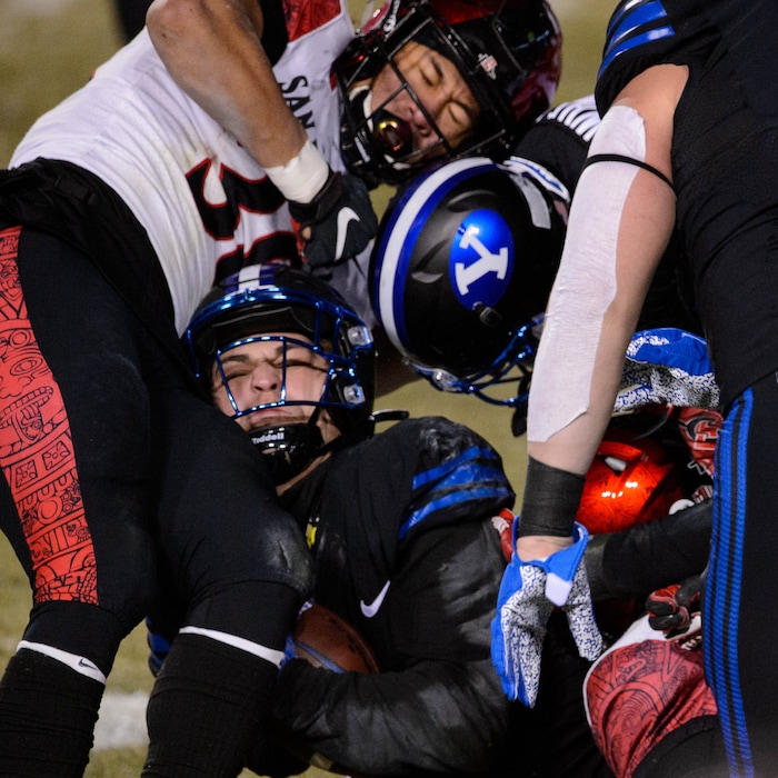(Trent Nelson | The Salt Lake Tribune) Brigham Young Cougars running back Lopini Katoa (4) runs into San Diego State Aztecs linebacker Andrew Aleki (38) as BYU hosts San Diego State, NCAA football in Provo on Saturday, December 12, 2020.