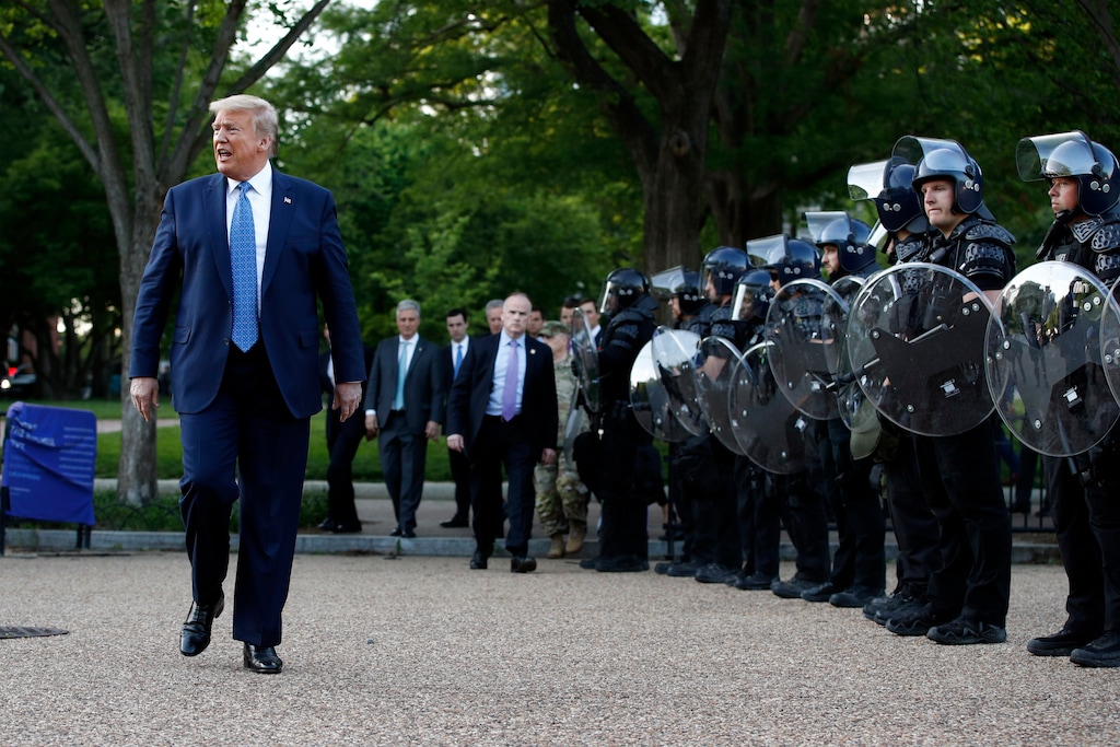 (Patrick Semansky | AP photo) President Donald Trump walks past police in Lafayette Park after he visited outside St. John's Church across from the White House Monday, June 1, 2020, in Washington. Part of the church was set on fire during protests on Sunday night.