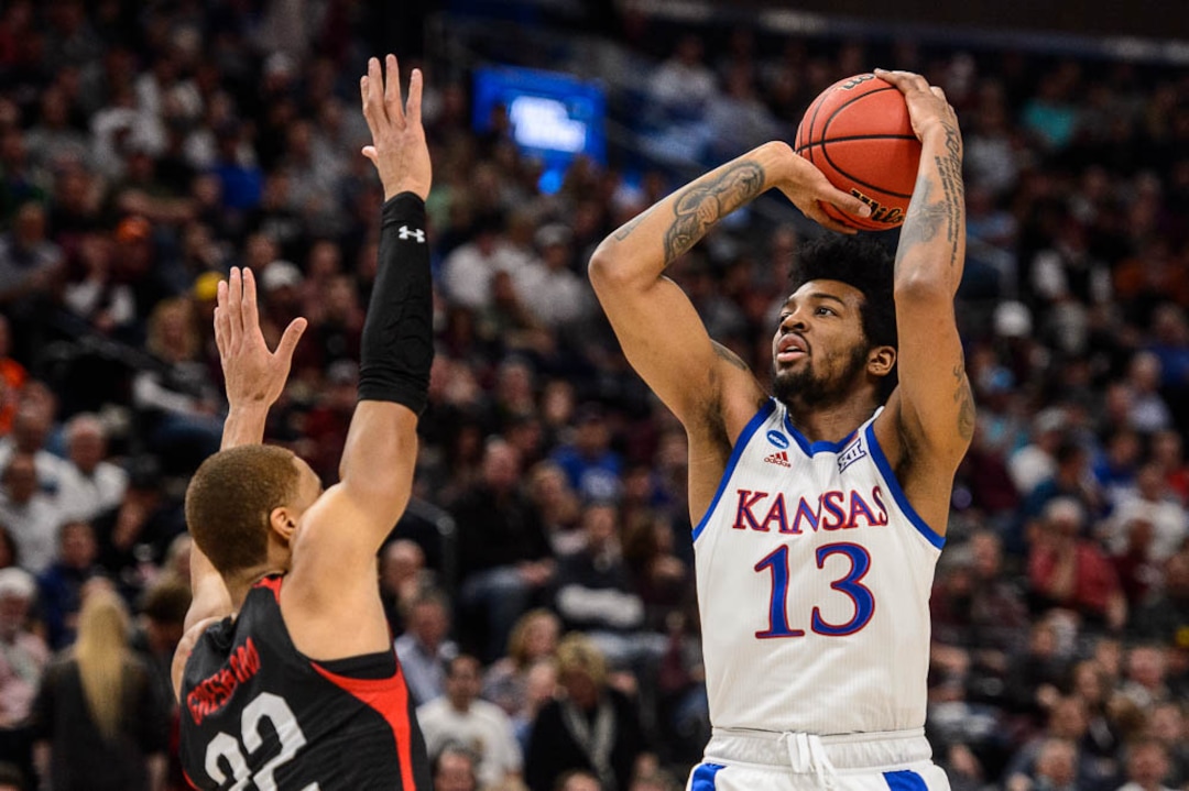 (Trent Nelson | The Salt Lake Tribune)  Kansas Jayhawks guard K.J. Lawson (13) shoots over Northeastern Huskies guard Donnell Gresham Jr. (22) as Kansas faces Northeastern in the 2019 NCAA Tournament in Salt Lake City on Thursday March 21, 2019.