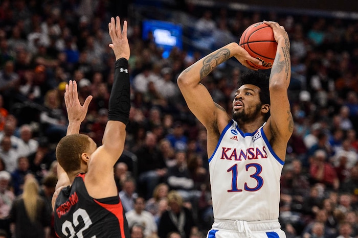 (Trent Nelson | The Salt Lake Tribune)  
Kansas Jayhawks guard K.J. Lawson (13) shoots over Northeastern Huskies guard Donnell Gresham Jr. (22) as Kansas faces Northeastern in the 2019 NCAA Tournament in Salt Lake City on Thursday March 21, 2019.