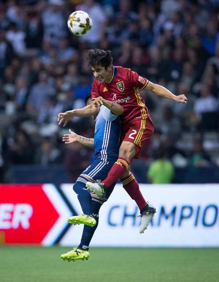 Real Salt Lake's Tony Beltran (2) and Vancouver Whitecaps' Cristian Techera vie for the ball during the second half of an MLS soccer match Saturday, Sept. 9, 2017, in Vancouver, British Columbia. (Darryl Dyck/The Canadian Press via AP)