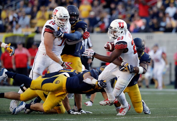 Utah running back Armand Shyne (23) is brought down by California defenders during the second half of an NCAA college football game Saturday, Oct. 1, 2016, in Berkeley, Calif.  California won 28-23. (AP Photo/Marcio Jose Sanchez)