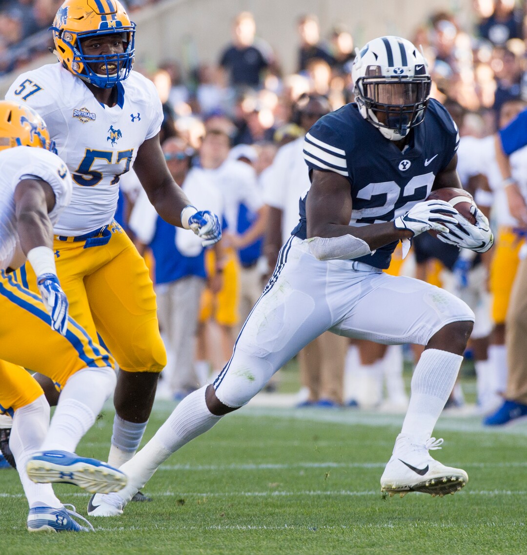 (Rick Egan  |  The Salt Lake Tribune)    Brigham Young Cougars running back Squally Canada (22) gets past McNeese State Cowboys defensive lineman Cody Roscoe (57) and McNeese State Cowboys defensive back Trent Jackson (9), in football action Brigham Young Cougars vs McNeese State Cowboys at Lavell Edwards Stadium, Saturday, Sept. 22, 2018.