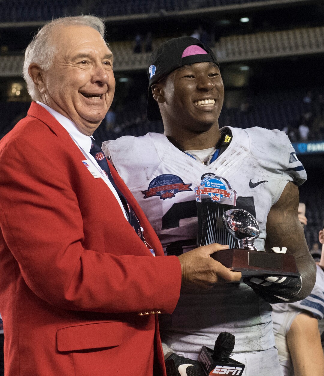 Rick Egan  |  The Salt Lake TribuneTed Tollner, Poinsettia Bowl President, presents  Brigham Young Cougars running back Jamaal Williams (21) the trophy for offensive MVP, in the Poinsettia Bowl, at Qualcomm Stadium in San Diego, December 21, 2016.
