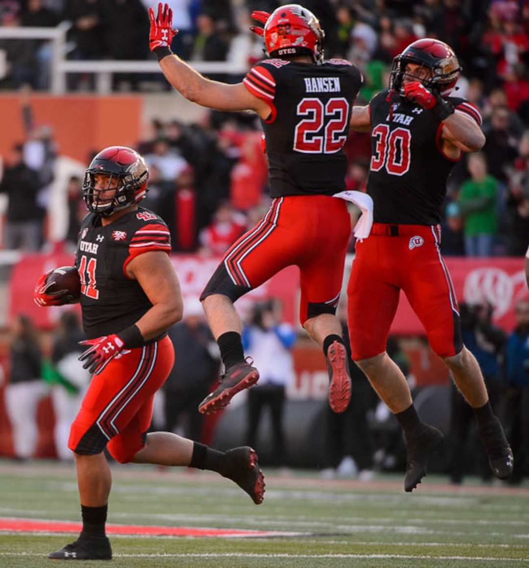 (Trent Nelson | The Salt Lake Tribune)  Utah Utes defensive tackle Hauati Pututau (41), Utah Utes linebacker Chase Hansen (22), and Utah Utes linebacker Cody Barton (30) celebrate a turnover. Utah Utes host the Oregon Ducks, NCAA football at Rice-Eccles Stadium in Salt Lake City on Saturday Nov. 10, 2018.