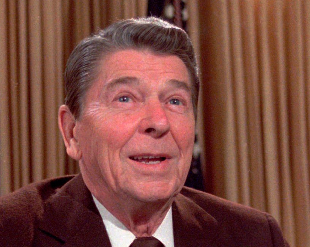 FILE - In this May 24, 1985, file photo, then U.S. President Ronald Reagan works at his desk in the oval office of the White House as he prepares a speech on tax revision.  (AP Photo/Scott Stewart, File)