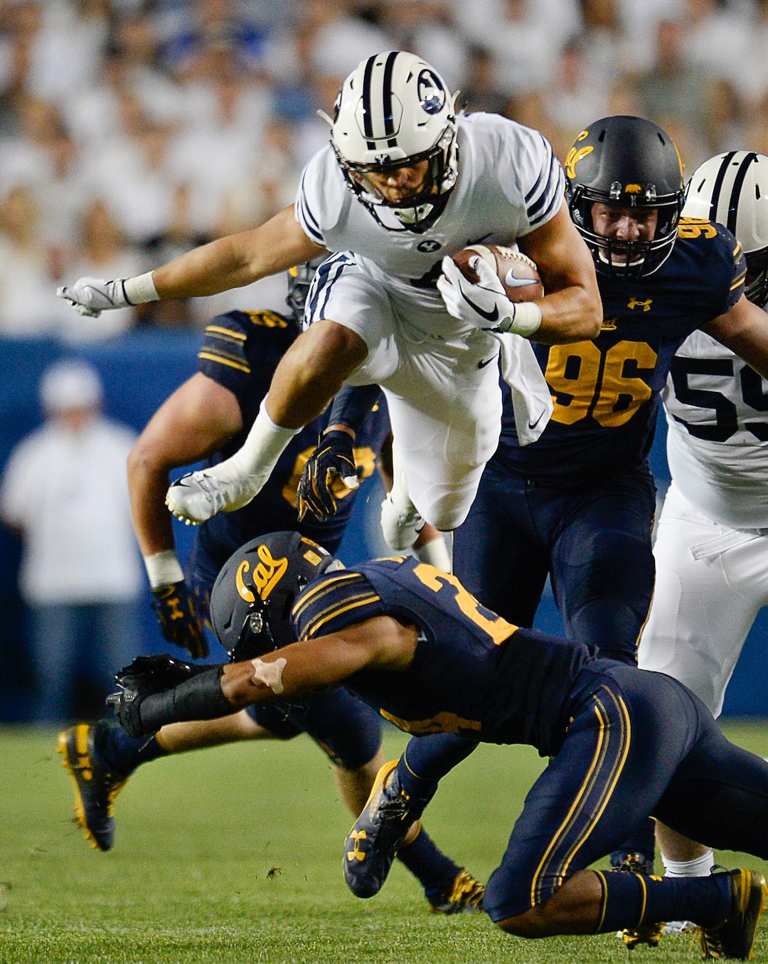 (Francisco Kjolseth  |  The Salt Lake Tribune)  Brigham Young Cougars running back Lopini Katoa (4) hurdles the California defense during the first half of the NCAA college football game, Saturday, Sept. 8, 2018, at LaVell Edwards stadium in Provo, Utah.