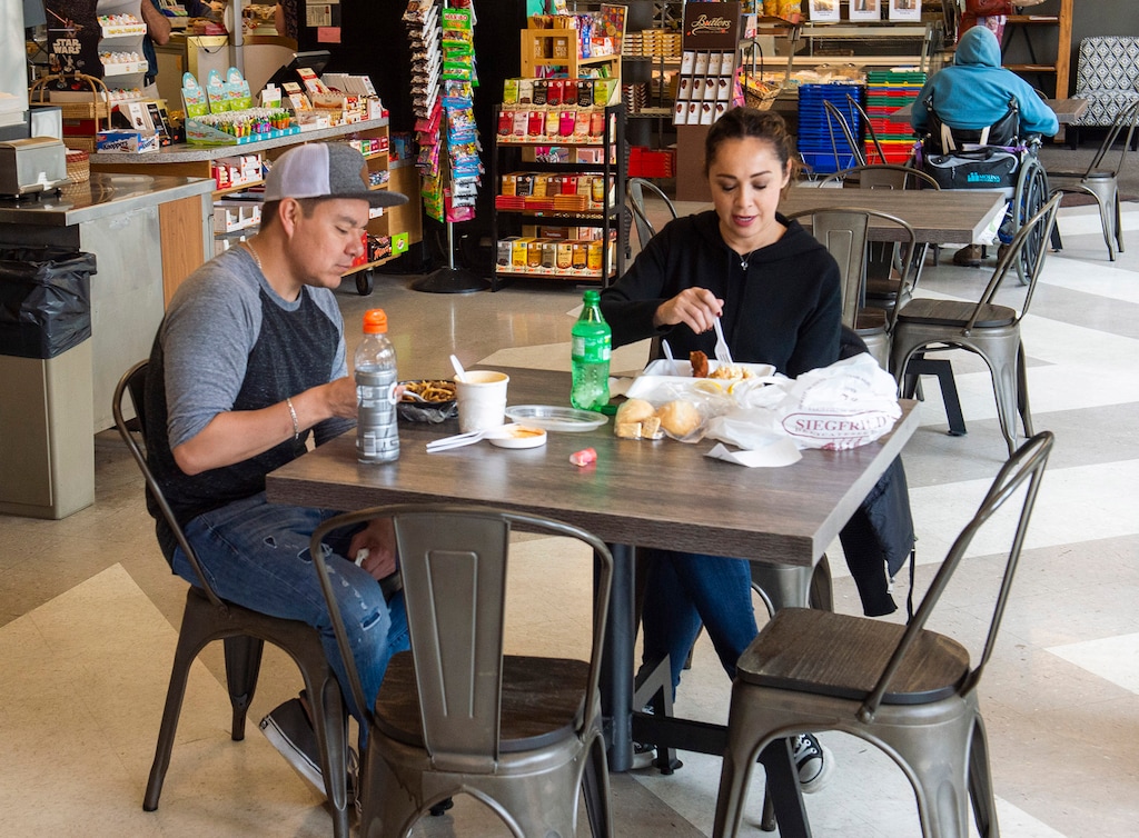 (Rick Egan  |  The Salt Lake Tribune)    Alex Olmos and Angelic Quintana dine inside Siegfried's Delicatessen, which is now open for indoor dining, Friday, May 1, 2020
