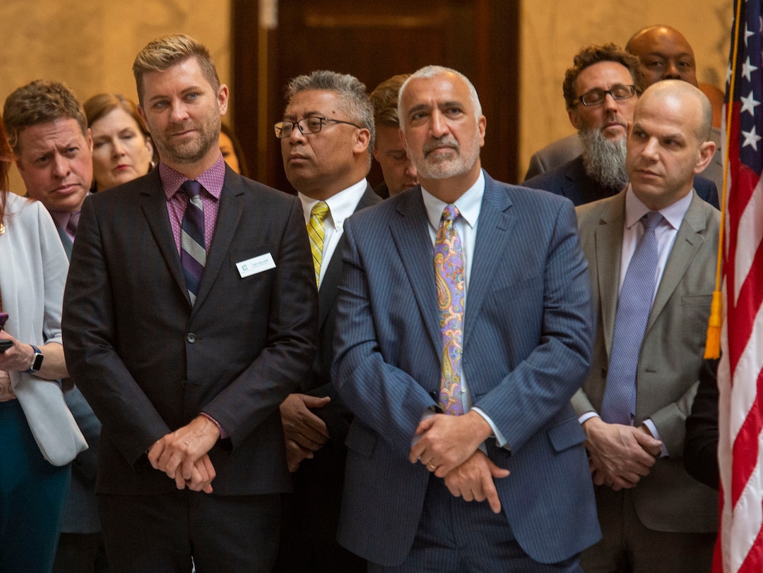 (Rick Egan  |  The Salt Lake Tribune)   Troy Williams and Sim Gill, listen to the speakers before Gov. Gary R. Herbert signed the new hate crimes bill, at the Utah State Capitol, Tuesday, April 2, 2019.