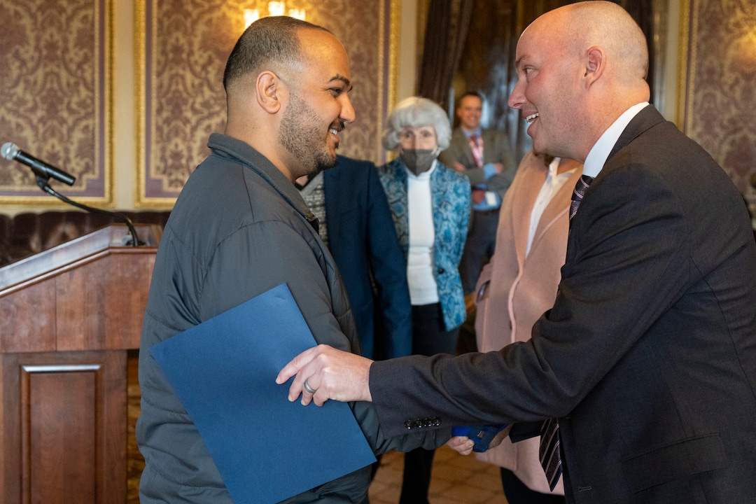 (Rick Egan | The Salt Lake Tribune) Ahmad Naweed Shirzad, an Afghan refugee, shakes hands with gov. Spencer Cox, in the Gold Room at the State Capitol during a news conference for "Afghan Day on the Hill" on Wednesday, Feb. 23, 2022.