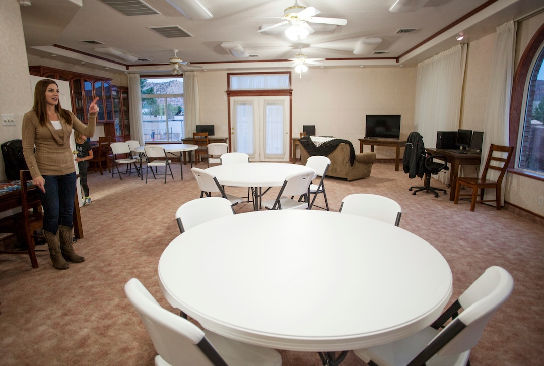 In this April 30, 2018, photo, Jena Jones, Director of the Short Creek Dream Center, guides a tour through the renovated facility, formally the home of polygamous sect leader Warren Jeffs in Hildale, Utah. The sprawling house surrounded by towering brick walls has been converted into a sober living center by Evangelical missionaries, the latest sign of the group’s dwindling control of the small community on the Utah-Arizona border. (Chris Caldwell/The Spectrum via AP)