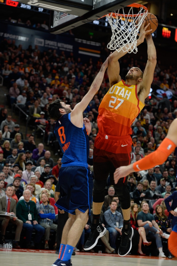 (Francisco Kjolseth  |  The Salt Lake Tribune)   Utah Jazz center Rudy Gobert (27) tries to drop one in past Oklahoma City Thunder guard Alex Abrines (8) in the NBA game at Vivint Smart Home Arena Sat., Dec. 22, 2018, in Salt Lake City.