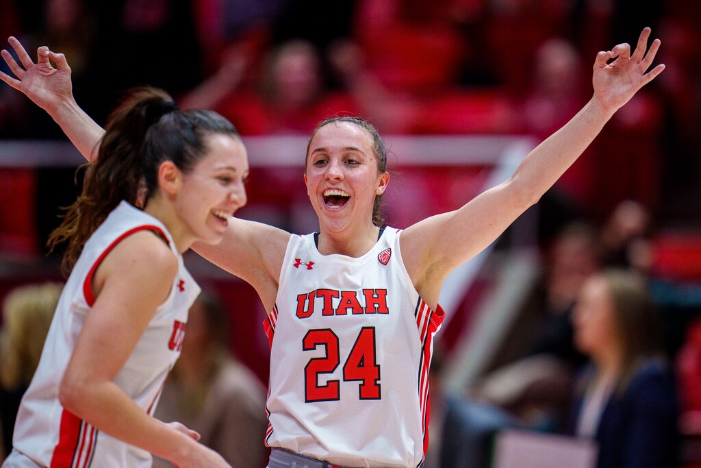 (Trent Nelson | The Salt Lake Tribune) Utah Utes guard Issy Palmer (1) and Utah Utes guard Kennady McQueen (24) celebrate Palmer's half court shot to end the first half as Utah hosts Washington, NCAA basketball in Salt Lake City on Friday, Feb. 10, 2023.