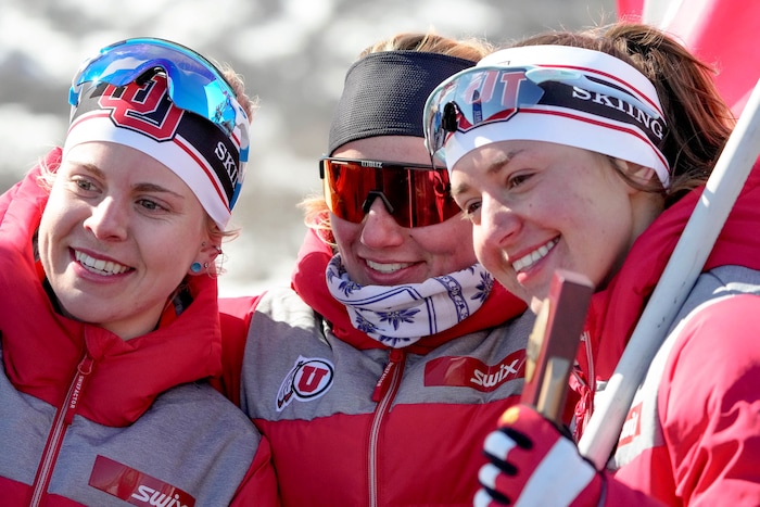 (Francisco Kjolseth | The Salt Lake Tribune) Sophia Laukli, Novie McCabe and Sydney Palmer-Ledger, from left, of the University of Utah celebrate after competing in the women’s 5K classic in the NCAA Skiing Championships held at the Soldier Hollow Nordic Center on Thursday, March 10, 2022 in Midway, Utah.