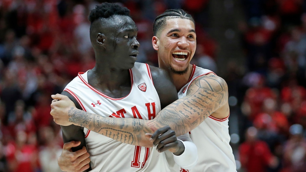 Utah's Timmy Allen, right, celebrates with Both Gach (11) after he scored against Colorado at the end of the second half during an NCAA college basketball game Saturday, March 7, 2020, in Salt Lake City. (AP Photo/Rick Bowmer)
