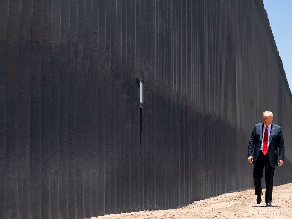 (Doug Mills | New York Times file photo) President Donald Trump walks along the border wall in San Luis, Ariz., June 23, 2020. "Suppose he had tried as relentlessly to battle the virus as he has to build his wall," writes New York Times opinion columnist Nicholas Kristof.
