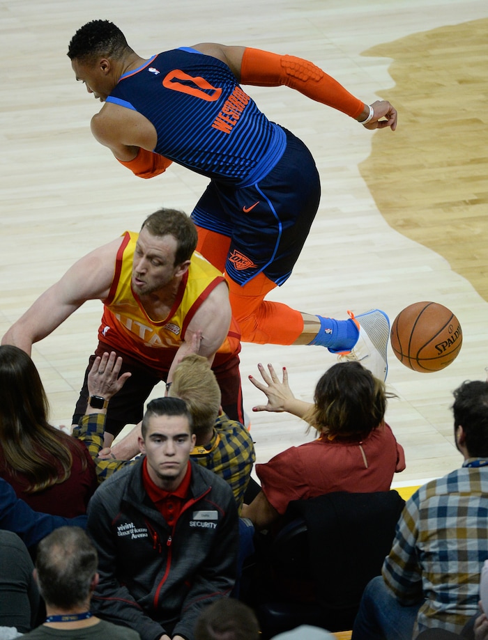 (Francisco Kjolseth  |  The Salt Lake Tribune)   Utah Jazz forward Joe Ingles (2) flies into the stands as he battles for a loose ball against Oklahoma City Thunder guard Russell Westbrook (0) in the NBA game at Vivint Smart Home Arena Sat., Dec. 22, 2018, in Salt Lake City.