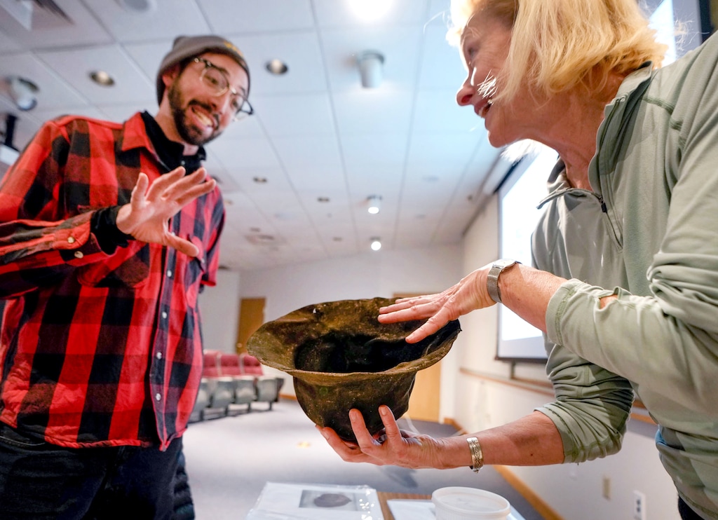 (Francisco Kjolseth | The Salt Lake Tribune) Archeologist Jeremy Moore is amazed by the restoration work being performed to a 150-year-old leather miners hat by Anna Lawlor, Collections Manager Natural History Museum, during a Alta history presentation on Friday, Jan. 9, 2026. Moore who was part of an archeological dig last year at Alta recognized the rare artifact unearthed by heavy machinery. 