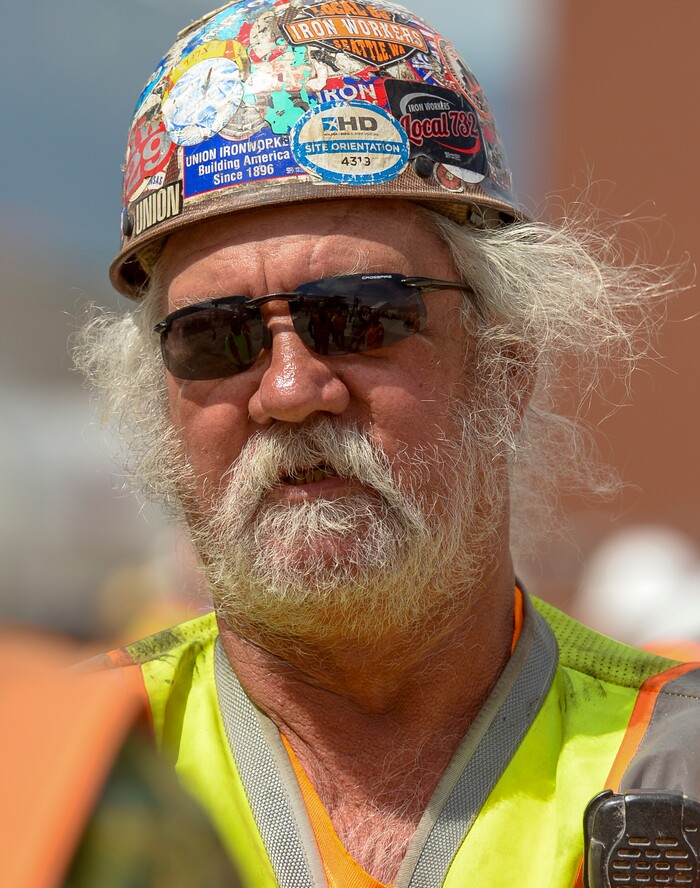 (Leah Hogsten  |  The Salt Lake Tribune) Iron Worker Bob Lane and crew with Local Union 27 positioned the last steel beam, topped with a tinsel decorated tree, during a "topping out" ceremony at the new Salt Lake City International terminal building, Wednesday, May 23, 2018. Such ceremonies can be traced to Scandinavian rites to place a tree atop a new building to appease the tree-dwelling spirits displaced during Construction.