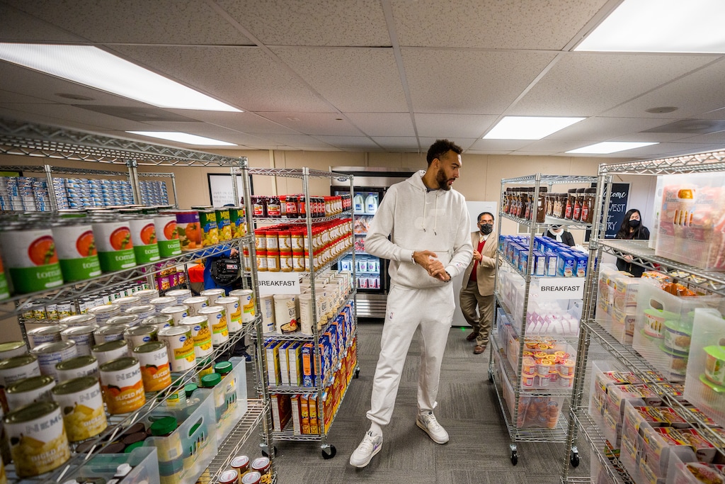 (Trent Nelson | The Salt Lake Tribune) Utah Jazz center Rudy Gobert visits Northwest Middle School to see the new food pantry, in Salt Lake City on Thursday, Oct. 14, 2021. Rudy's Kids Foundation, Smith's Food and the Salt Lake Education Foundation combined efforts to open the food pantry. At rear is James Yapias of the Salt Lake Education Foundation.