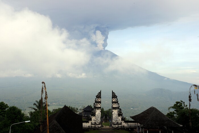 (Firdia Lisnawati | The Associated Press) Clouds of ashes raise from the Mount Agung volcano erupting in Karangasem, Indonesia, Monday, Nov. 27, 2017. Indonesia authorities raised the alert for the rumbling volcano to highest level on Monday and closed the international airport on tourist island of Bali stranding thousands of travelers.