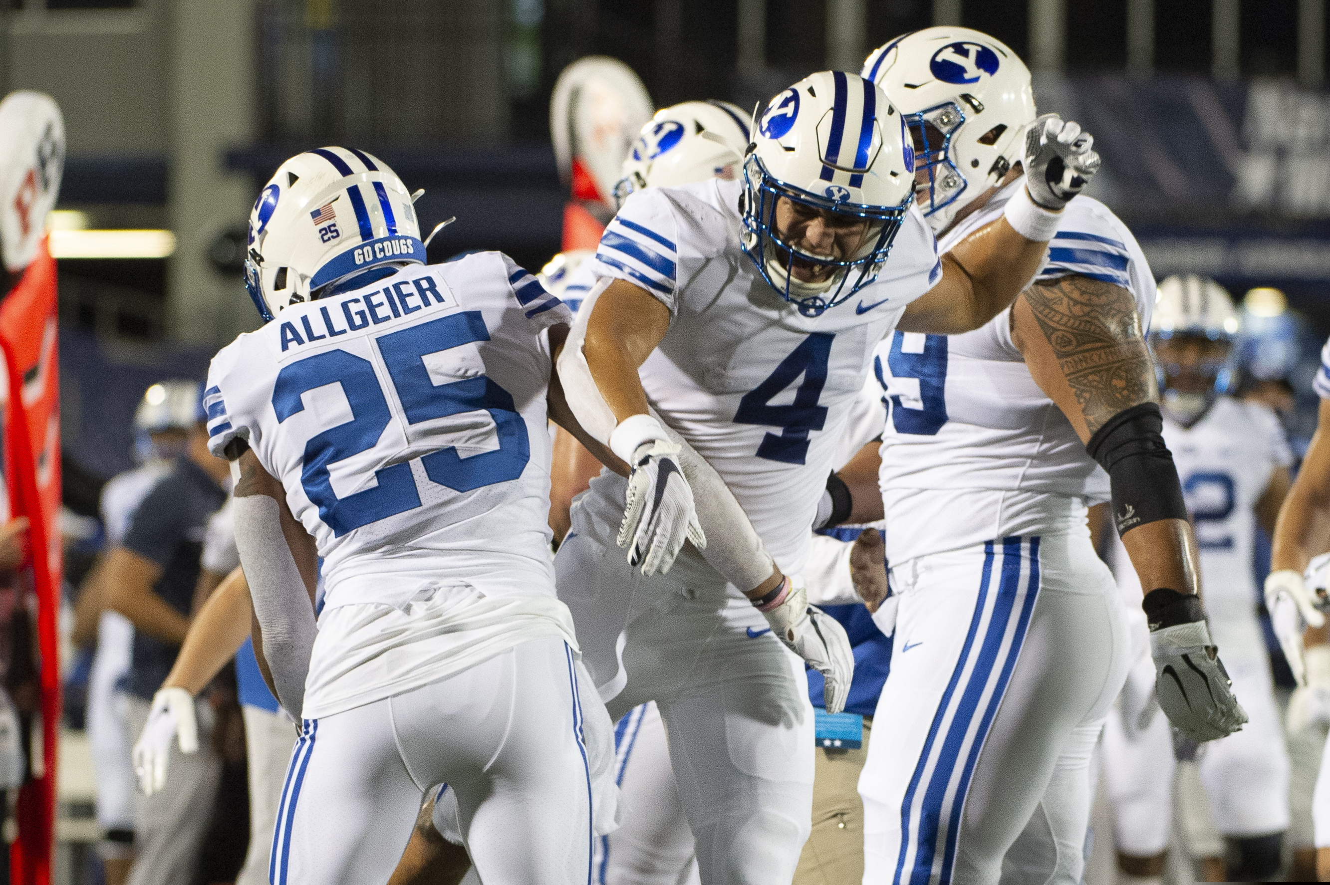 (Tommy Gilligan | The Associated Press) BYU's Lopini Katoa (4) and Tyler Allgeier (25) celebrate during the first half of an NCAA college football game against Navy, Monday, Sept. 7, 2020, in Annapolis, Md.