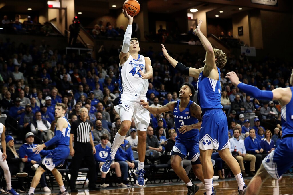 (Josh Jurgens | AP) Creighton Forward Ryan Hawkins (44) shoot over a BYU defender during an NCAA college basketball game Saturday, Dec. 11, 2021, in Sioux Falls, S.D.