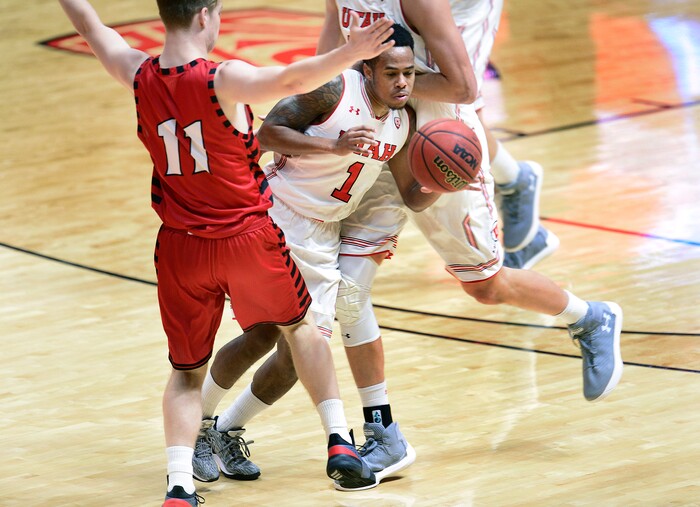 (Scott Sommerdorf   |  The Salt Lake Tribune)   Utah G Justin Bibbins gets sandwiched between Eastern Washington's Jack Perry and a team mate during first half play. Utah defeated Eastern Washington 85-69, Friday, November 24, 2017. 