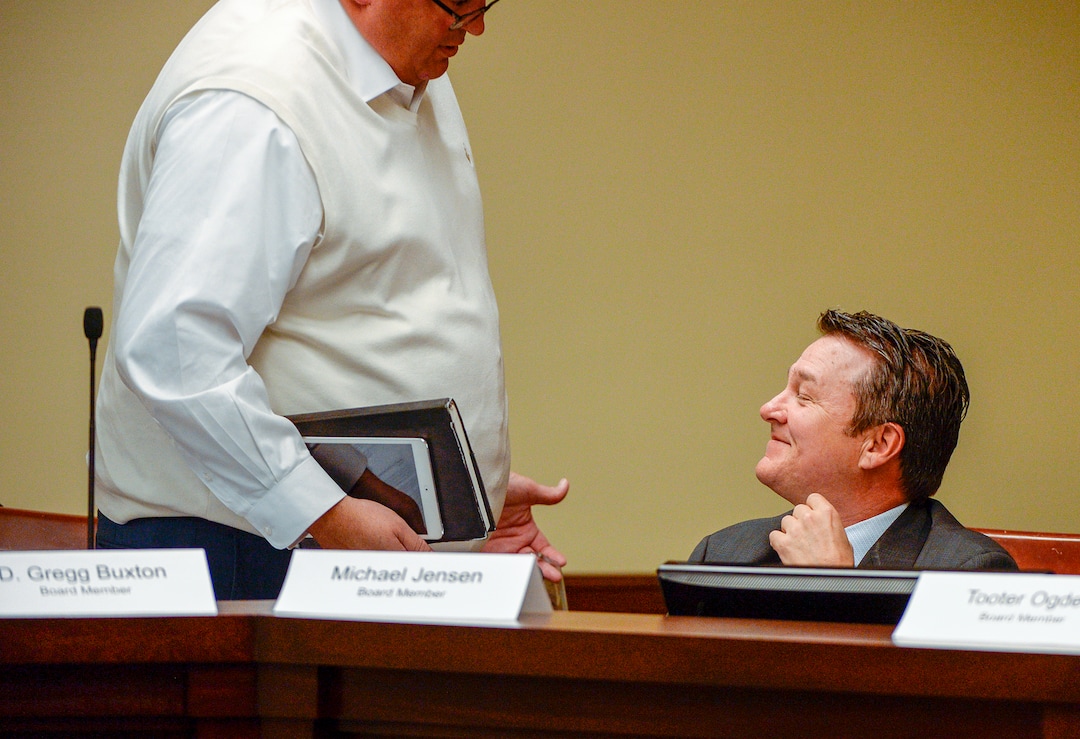 Leah Hogsten  |  The Salt Lake Tribune  Michael H. Jensen, Inland Port Authority board member is greeted by fellow board member Rep. Francis Gibson, R-Mapleton, Sept. 26, 2018. Before the Inland Port board met Wednesday, a coalition of community, environmental and civic organizations have raised a separate transparency issue, noting that the group’s proposed half-page budget lacks specificity. The coalition wants to see the board acknowledge concern within the community, provide more details about its budget and fund an investigation into potential environmental harms from development of the port. 