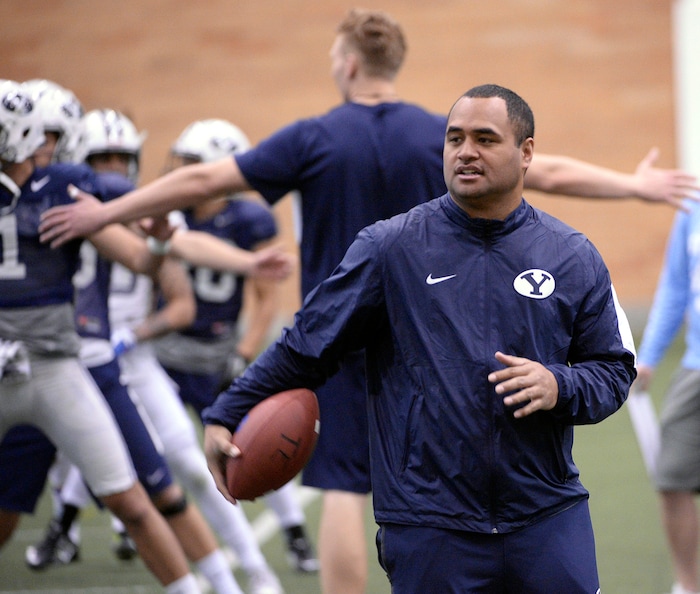 Al Hartmann  |  The Salt Lake Tribune
BYU's new running back coach Reno Mahe works with his players during practice Tuesday March 22.  