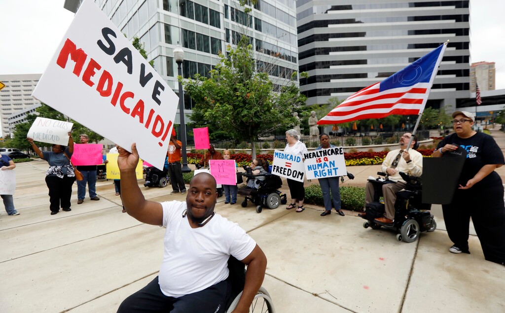 Mario Henderson leads chants of "save Medicaid," as other social service activists, Medicaid recipients and their supporters stage a protest outside the building that houses the offices of U.S. Sen. Thad Cochran, R-Miss., Thursday, June 29, 2017, in Jackson, Miss. Soaring prices and fewer choices may greet customers when they return to the Affordable Care Act’s insurance marketplaces in the fall of 2017, in part because insurers are facing deep uncertainty about whether the Trump administration will continue to make key subsidy payments and enforce other parts of the existing law that help control prices. (AP Photo/Rogelio V. Solis)