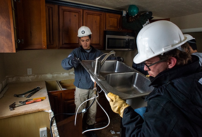(Rick Egan  |  The Salt Lake Tribune)       Uri Sarig and Jeremiah Jenkins from AmeriCorps, removes a the kitchen sink from a home that will be demolished for freeway widening, for UDOT and Habitat for Humanity, Wednesday, Jan. 16, 2019.





