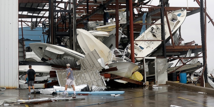(AP Photo | Eric Gay) Men checks on a boat storage facility that was damaged by Hurricane Harvey, Saturday, Aug. 26, 2017, in Rockport, Texas.