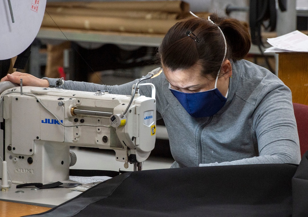 (Rick Egan  |  The Salt Lake Tribune)     Bata Barker wears one of the masks produced by her company, as she sews at SugarHouse Industries, which is making face masks and face shields, to protect against coronavirus, Thursday, March 26, 2020.