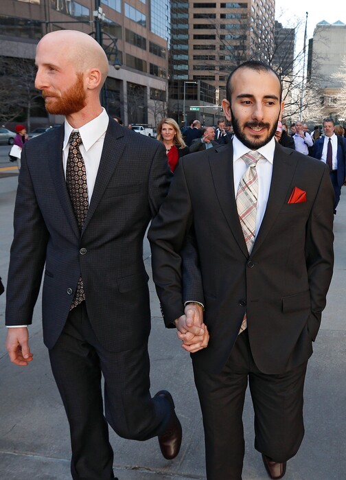 Plaintiffs challenging Utah's gay marriage ban Moudi Sbeity, right, and his partner Derek Kitchen, hold hands as they leave the courthouse following a hearing at the U.S. Circuit Court of Appeals in Denver, Thursday, April 10, 2014. The court is to decide if it agrees with a federal judge in Utah who in mid-December overturned a 2004 voter-passed gay marriage ban, saying it violates gay and lesbian couples' rights to due process and equal protection under the 14th Amendment. (AP Photo/Brennan Linsley)