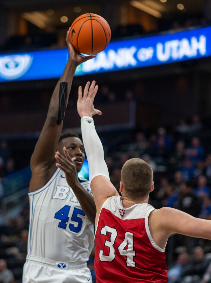 (Rick Egan | The Salt Lake Tribune)  Brigham Young Cougars forward Fousseyni Traore (45) shoots over South Dakota Coyotes forward Tasos Kamateros (34), in basketball action between the Brigham Young Cougars and the South Dakota Coyotes, at Vivint Arena, in Salt Lake City, on Saturday, Dec. 3, 2022.

