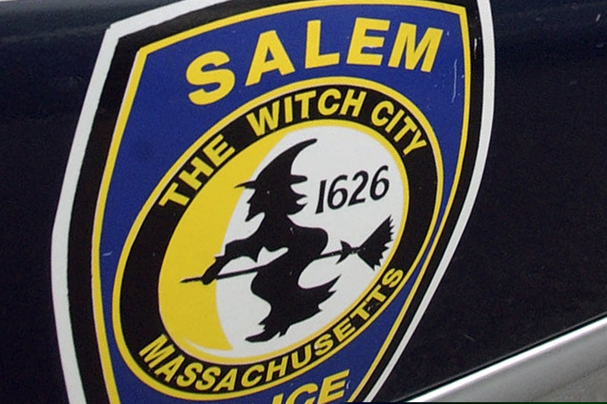 (Lisa Poole | AP file photo)
 In this Dec. 26, 2003, photo, the logo for the Salem Police Department, which bears an image of a witch, is displayed on a police cruiser's door in Salem, Mass.