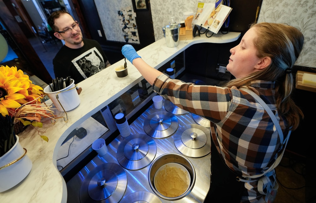 (Francisco Kjolseth | The Salt Lake Tribune) Shaun Matthews visits the Hidden Oak Gourmet Creamery for the first time as Lilly Stone dishes out a creamy delight, Friday, Nov. 7, 2025. After three years of pop-ups and farmers markets, the creamery — owned by Stone's dad, Jeff Olpin — has opened at Church and State on 400 South in Salt Lake City.