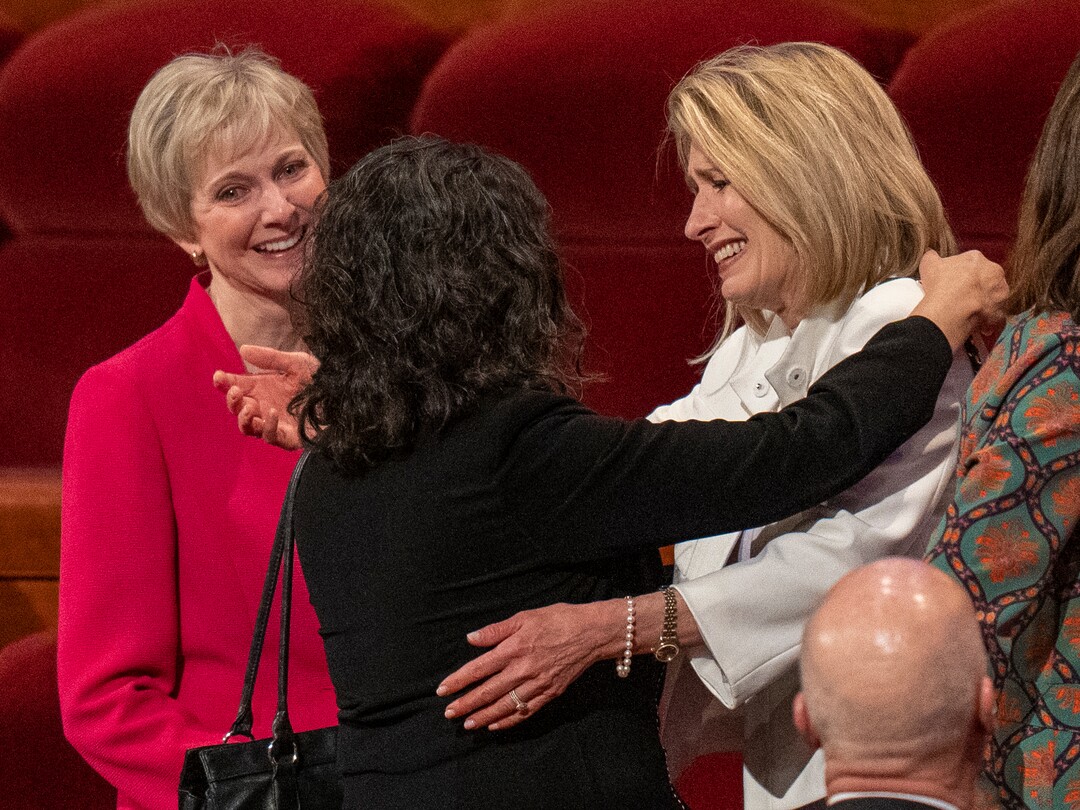 (Rick Egan | The Salt Lake Tribune)  Jean Bingham and Reyna Aburto hug the incoming Relief Society general President Camille N. Johnson after the afternoon session of LDS General Conference on Saturday, April 2, 2022.
