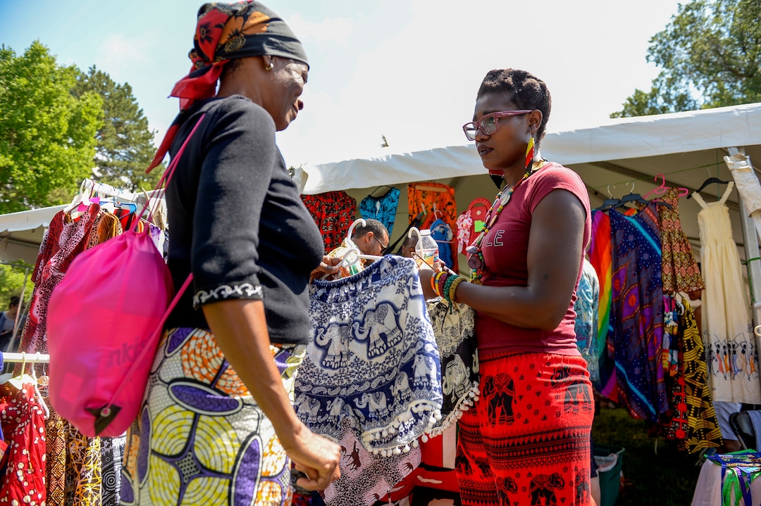 (Leah Hogsten  |  The Salt Lake Tribune)  Emma Ang'ila, right, sells Kenyan clothing, artwork and jewelry made by her mother who owns a store in Nairobi during the 4th Annual African Festival sponsored by the United Africans of Utah, Saturday, July 27, 2019 at Liberty Park. The African Festival promotes African tradition, culture and heritage through the arts, food fashion, music and dance.